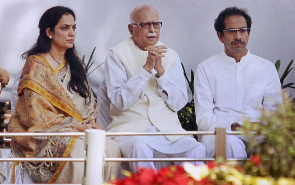 Senior BJP leader L K Advani with Shiv Sena president Uddhav Thackeray and his wife Rashmi Thackeray during their visit to the Late Balasaheb Thackeray memorial on his first death anniversary at Shivaji Park in Mumbai.