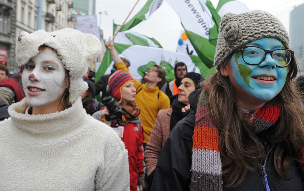Climate activists march through to campaign against global warming, in downtown Warsaw, Poland.
