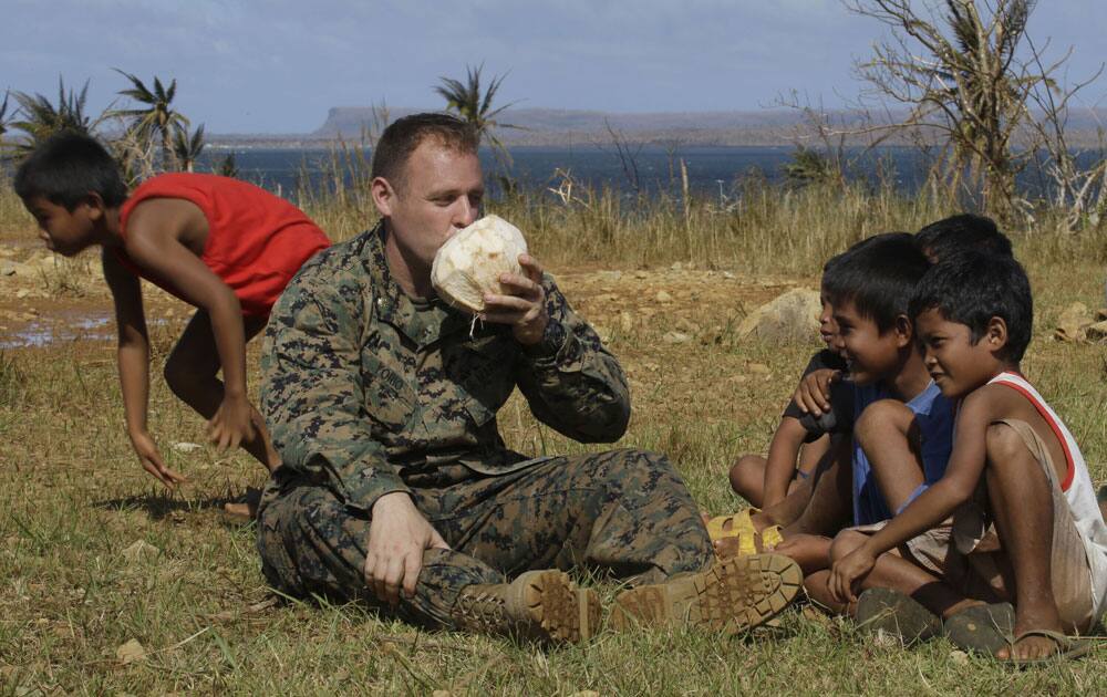 US Marine Maj. John Orio from San Diego, CA, drinks fresh coconut juice upon landing on Manicani island which was isolated by super typhoon Haiyan.