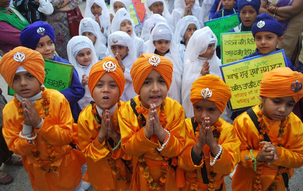 Young Sikhs participate in a religious procession on the eve of the birth anniversary of Guru Nanak in Amritsar.