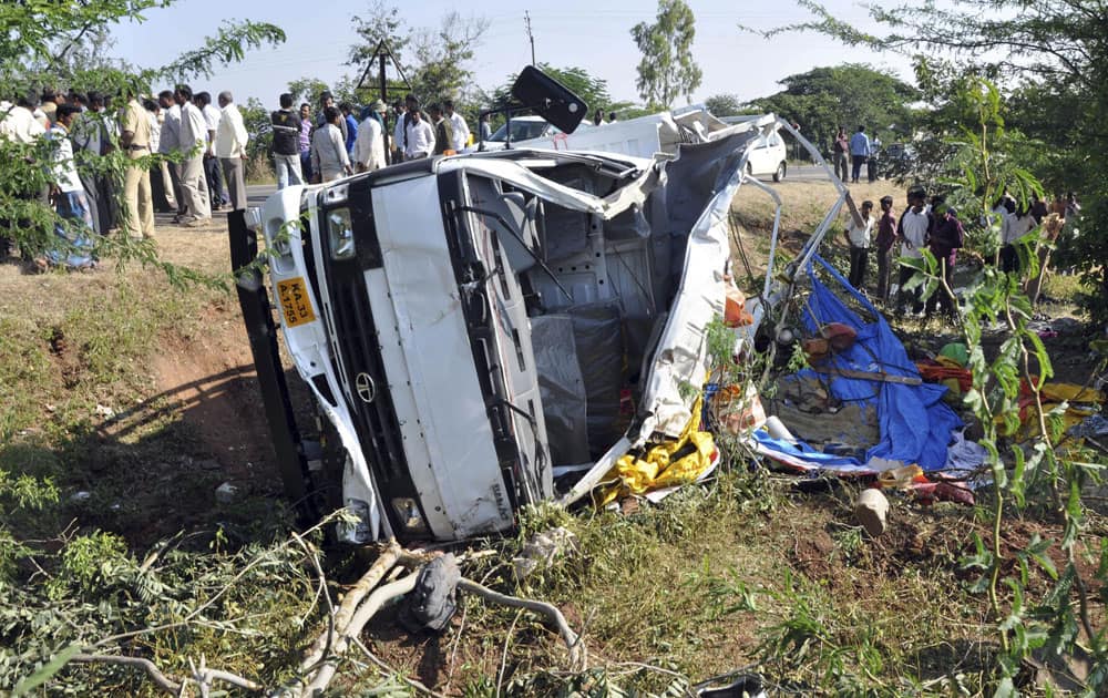 A truck lies mangled after it overturned on a potholed road near Belgaum, in the western Indian Karnataka state.