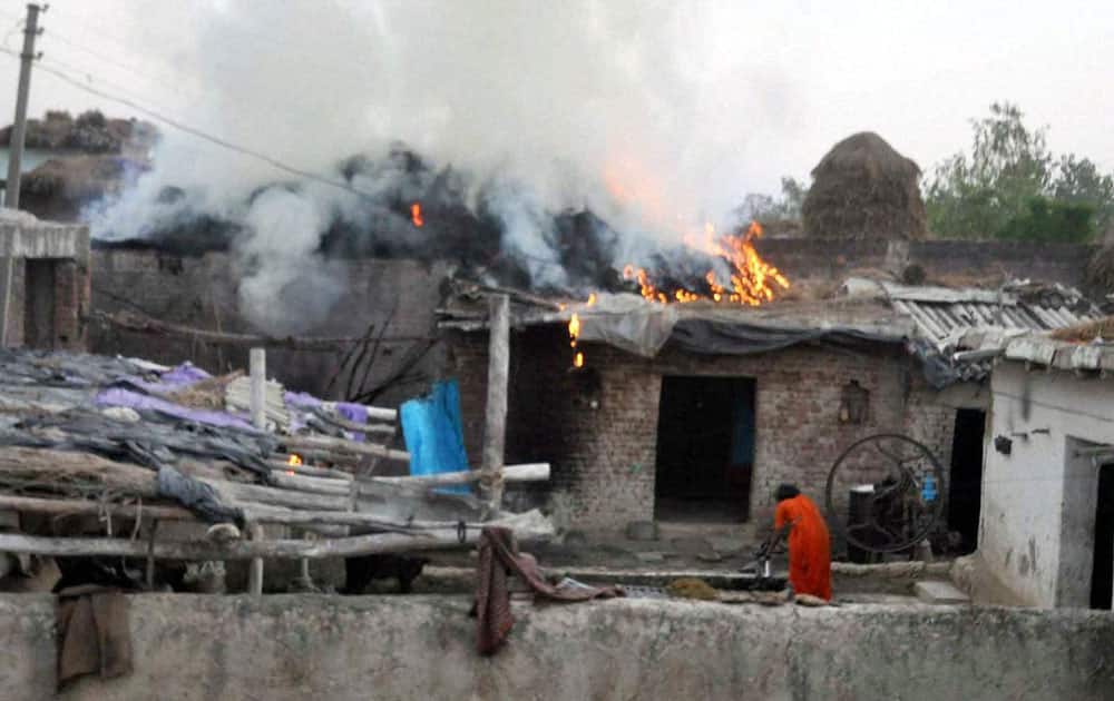 A house on fire after a clash broke out between two groups during Muharram procession in Moradabad.