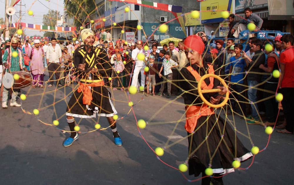 Sikhs show their skills during a procession on 545th birth anniversary of Guru Nanak Dev ji in Gurgaon.