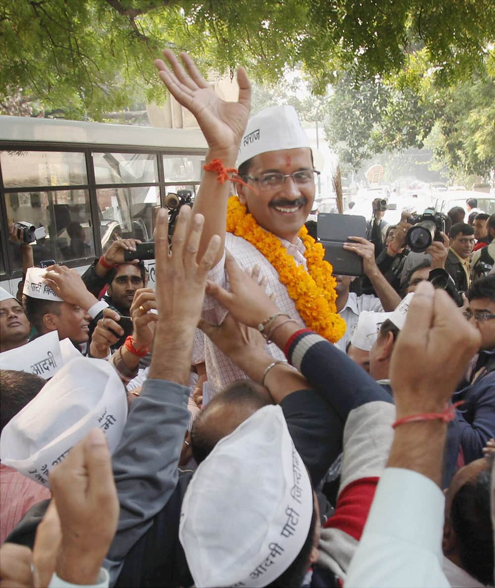 AAP convener Arvind Kejriwal wave to the supporters after filing his nomination papers from the New Delhi constituency at Jamnagar House in New Delhi.