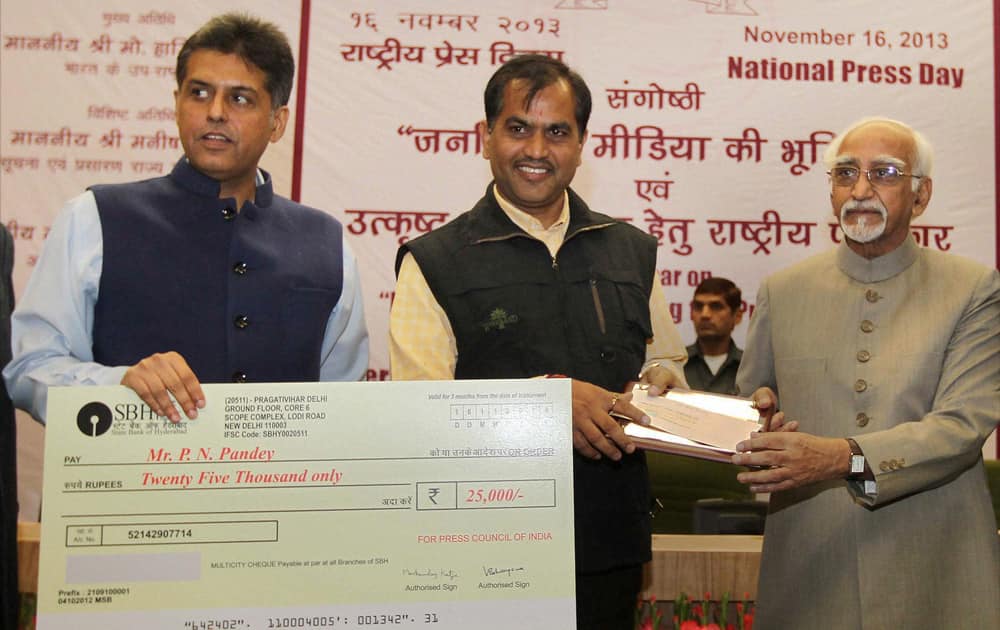 Vice President Hamid Ansari with Union I&B Minister Manish Tewari presenting National awards for `Excellence in Journalism` to Prem Nath Panday of `Indian Express`, during the National Press Day celebrations in New Delhi.