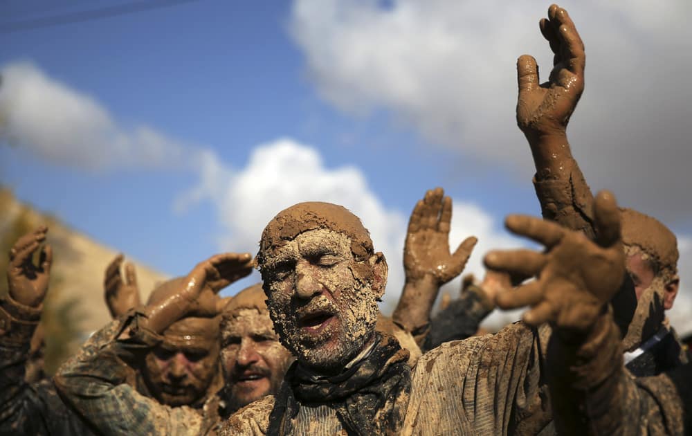 An Iranian Shiite is covered in mud during Ashoura rituals, marking the death anniversary of Imam Hussein, the grandson of Islam`s Prophet Muhammad, at the city of Bijar, west of the capital Tehran, Iran.