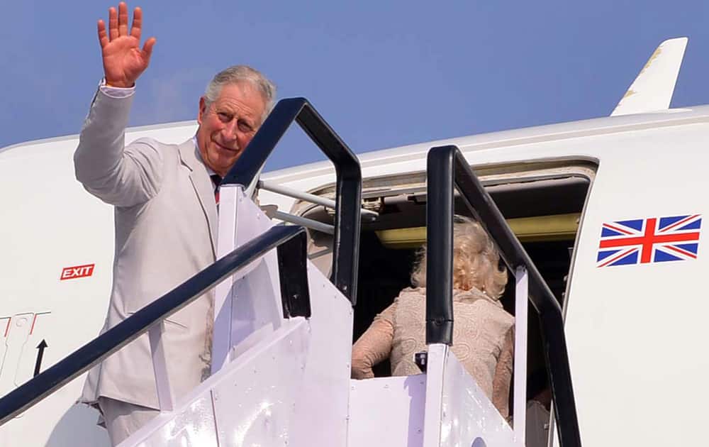Britain`s Prince Charles waves as he boards an aircraft to Colombo after a nine-day visit to India, in Kochi.