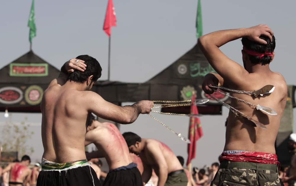 Afghan Shiites beat themselves with chains and blades to mark Ashura outside the Abul Fazel Shrine in Kabul, Afghanistan.