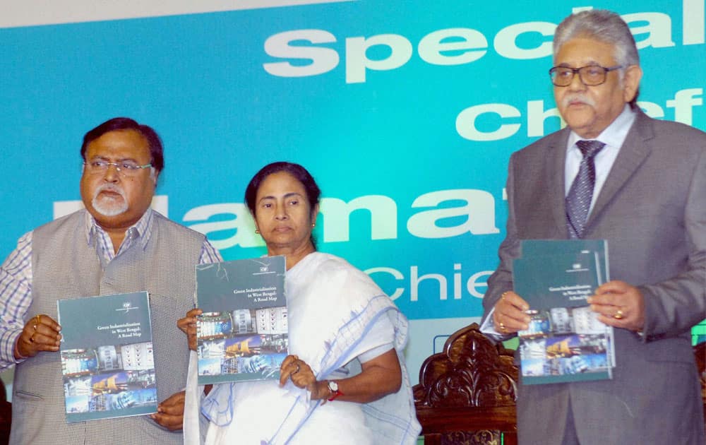 West Bengal Chief Minister Mamata Banerjee Mamata Banerjee launching CII Biz Bridge Directory with State Commerce & Industry Minister Partha Chatterjee and Sumit Mazumdar (R), Vice President, Confederation of Indian Industry at the Special Plenary session during `4th Biz Bridge`, an engineering & manufacturing exhibition and conference, in Kolkata.
