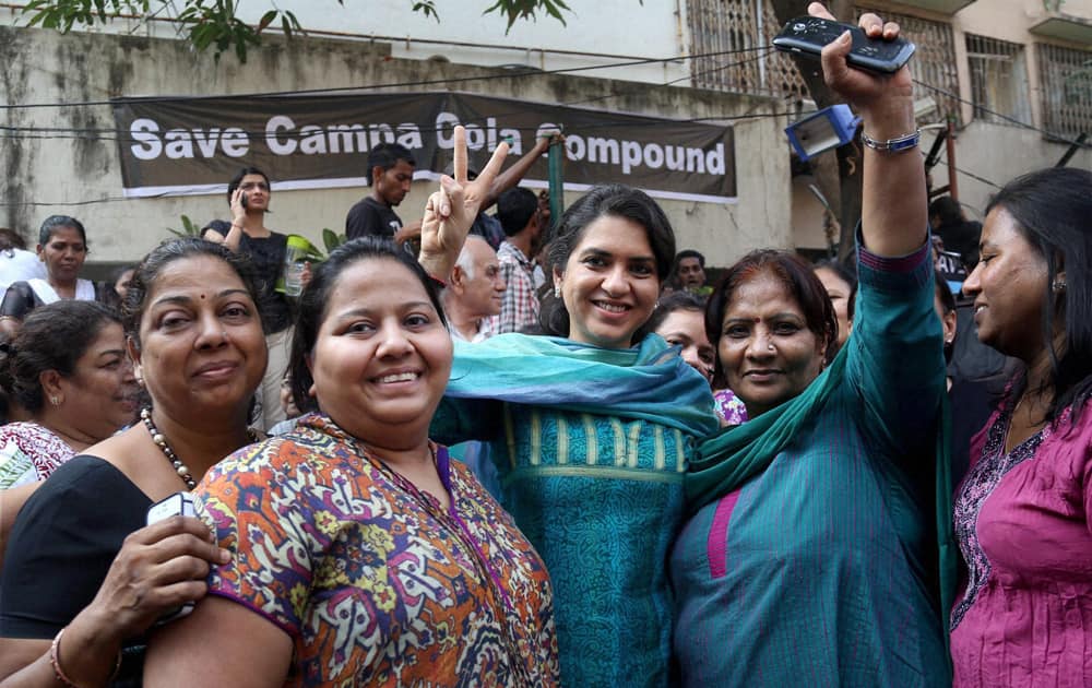 Residents of Campa Cola housing colony jubilate after the Supreme Court issued orders to stay the demolition of their houses in Mumbai.