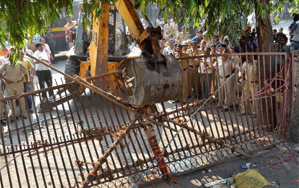 BMC men carry out demolition at Mumbai`s Campa Cola housing colony amid tight security, in Mumbai on Wednesday after a court deadline to vacate the flats ended.