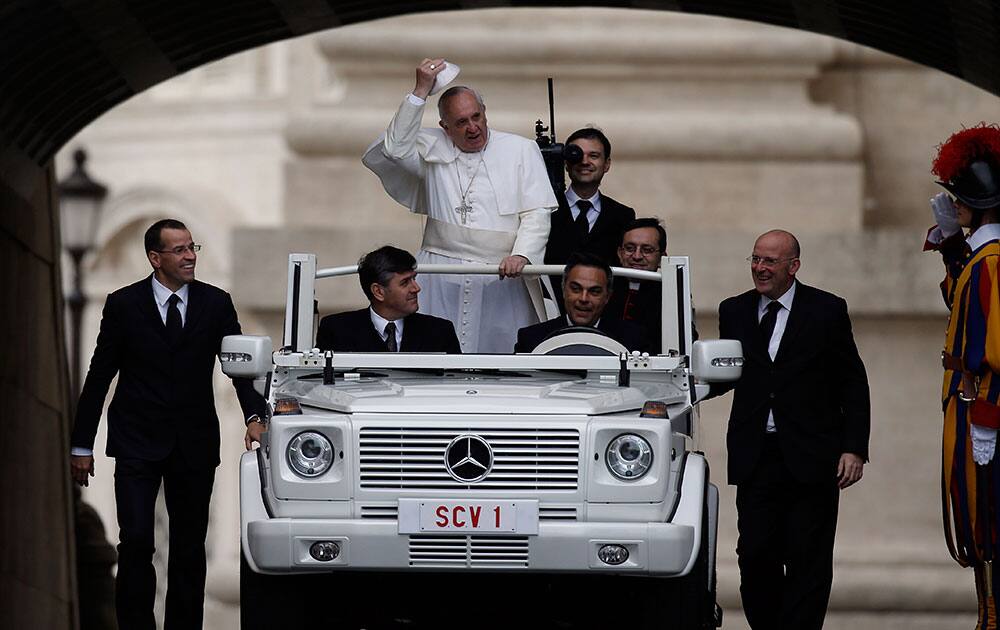Pope Francis, escorted by security guards, arrives in St.Peter`s Square for the weekly general audience, at the Vatican.