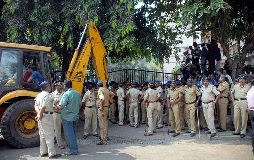 A policeman stands in front of a gate blocked by residents of Mumbai`s Campa Cola housing colony in Mumbai.