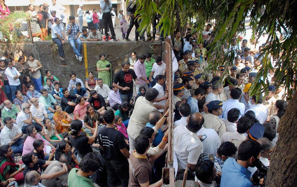Policemen gather outside the Campa Cola Compound as its residents protest against the demolition of their houses in Mumbai.