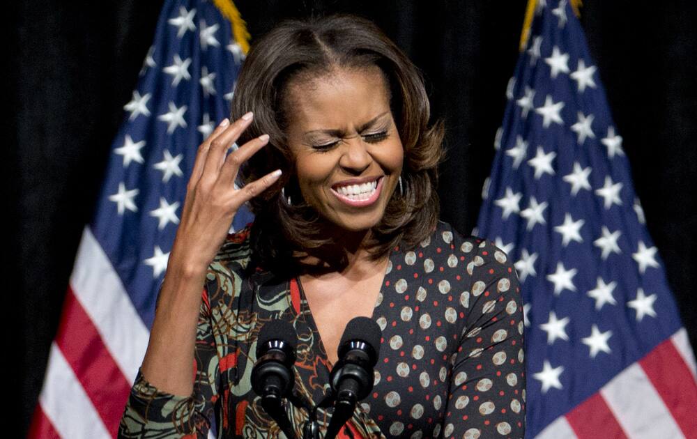 First lady Michelle Obama gestures as he speaks to students about committing to education to create a better future for themselves and their country, at Bell Multicultural High School in Washington.