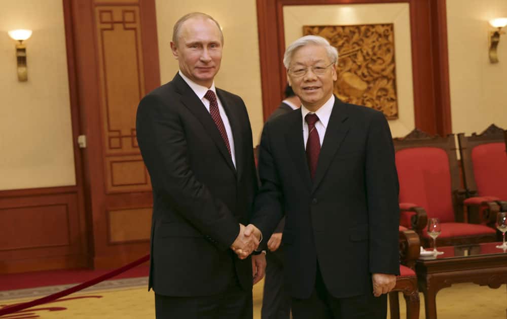 Russian President Vladimir Putin, left, shakes hands with Vietnamese Communist Party General Secretary Nguyen Phu Trong in Hanoi, Vietnam.