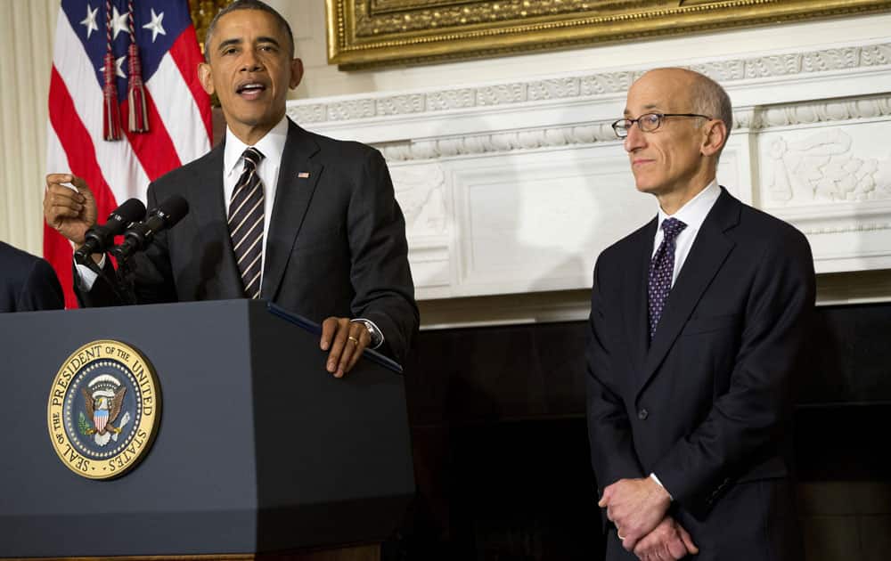 President Barack Obama announces that he will nominate Timothy Massad, right, to become chairman of the Commodity Futures Trading Commission (CFTC), in the State Dining Room of the White House in Washington.