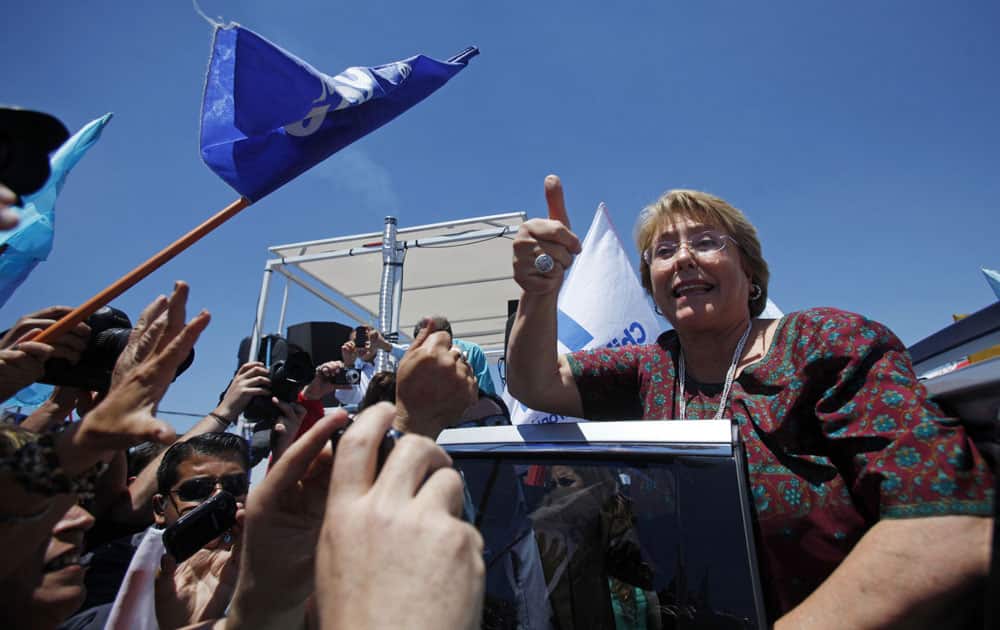 Chile`s former President Michelle Bachelet gives a thumbs up to supporters as she campaigns for reelection in Santiago, Chile.