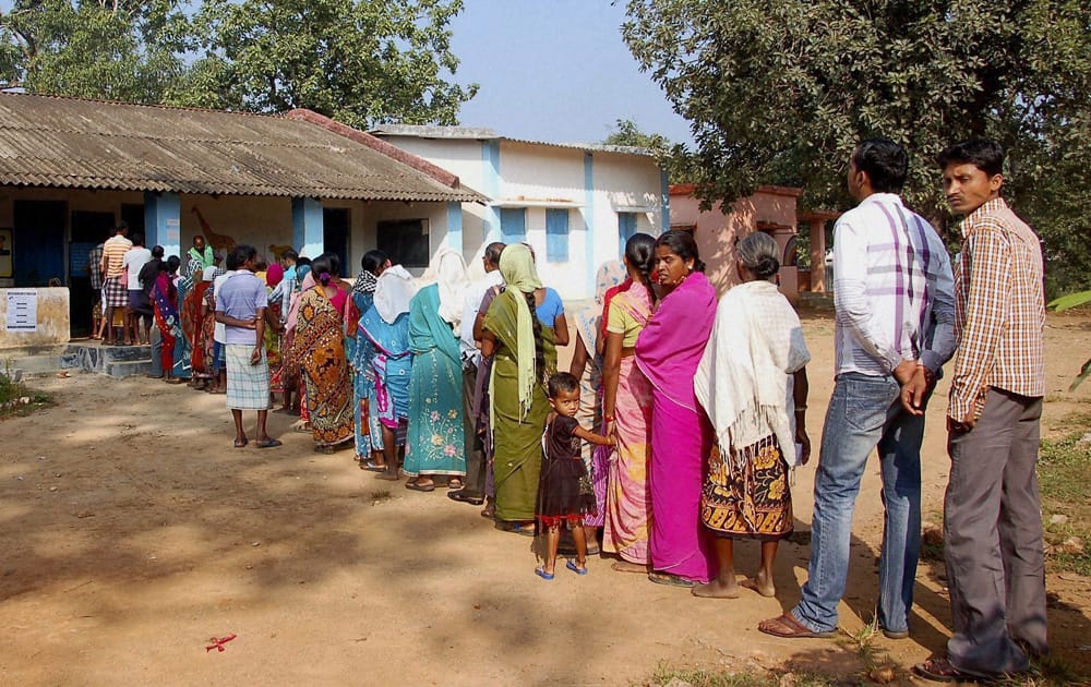 People wait to cast their votes at a polling booth in Dantewada during the first phase of polling for Chhattisgarh Assembly elections.