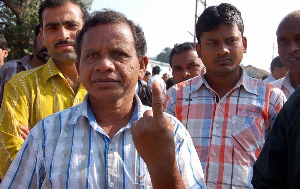 A voter shows his finger marked with indelible ink after casting his vote at a polling station in Dantewada during the first phase of polling for Chhattisgarh Assembly elections.