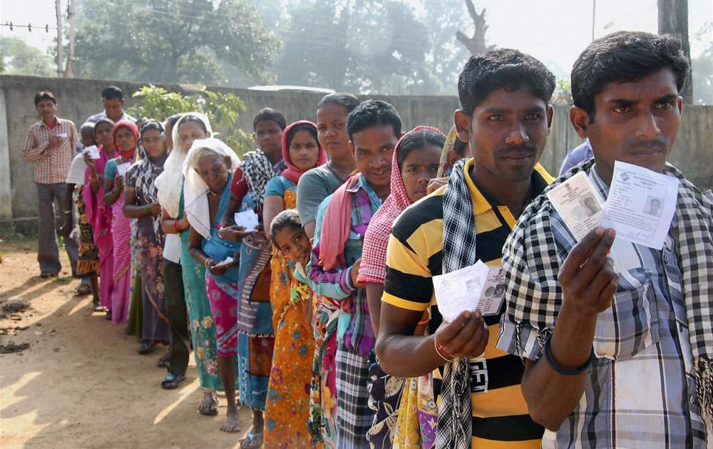 People wait to cast their votes at a polling booth in Dantewada during the first phase of polling for Chhattisgarh Assembly elections.