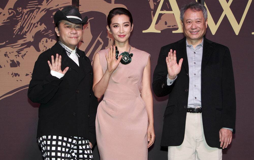Taiwanese director Ang Lee, right, Chinese actress Li Bing Bing, center, and Taiwanese host Kevin Tsai smile during a media event for the 50th Golden Horse Awards in Taipei, Taiwan.