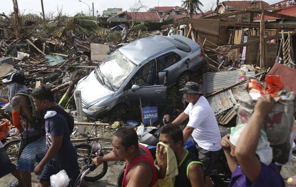 Survivors move past the damage caused by Typhoon Haiyan in Tacloban city, Leyte province, central Philippines.
