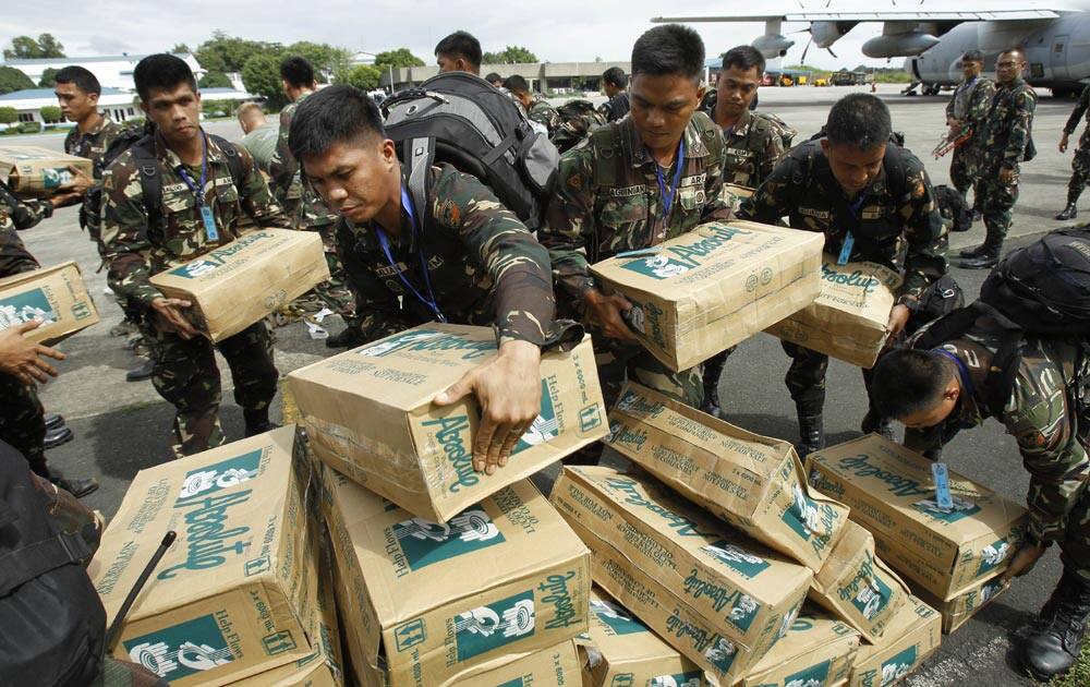 Personnel of the Philippines Army 51st engineer corps load water for victims of Typhoon Haiyan at Villamor Air Force Base in Manila, Philippines.
