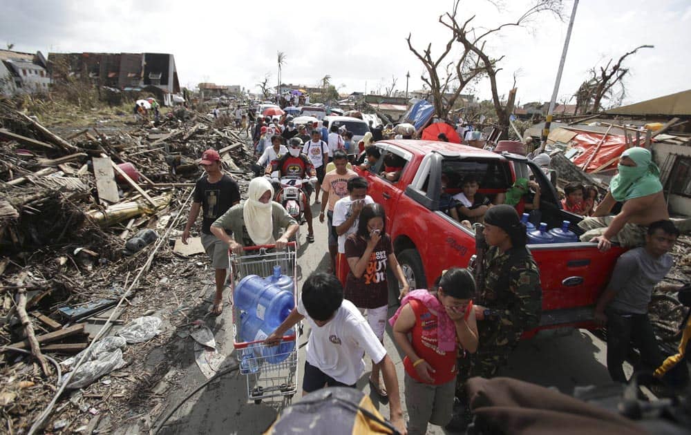 Survivors fill the streets to the downtown area as they race for supplies at typhoon ravaged Tacloban city, Leyte province central Philippines.
