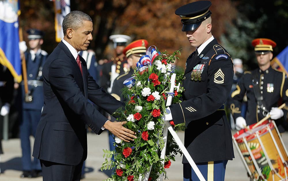 President Barack Obama places a wreath at the Tomb of the Unknowns at Arlington National Cemetery in Arlington, Va., during a Veterans Day ceremony.