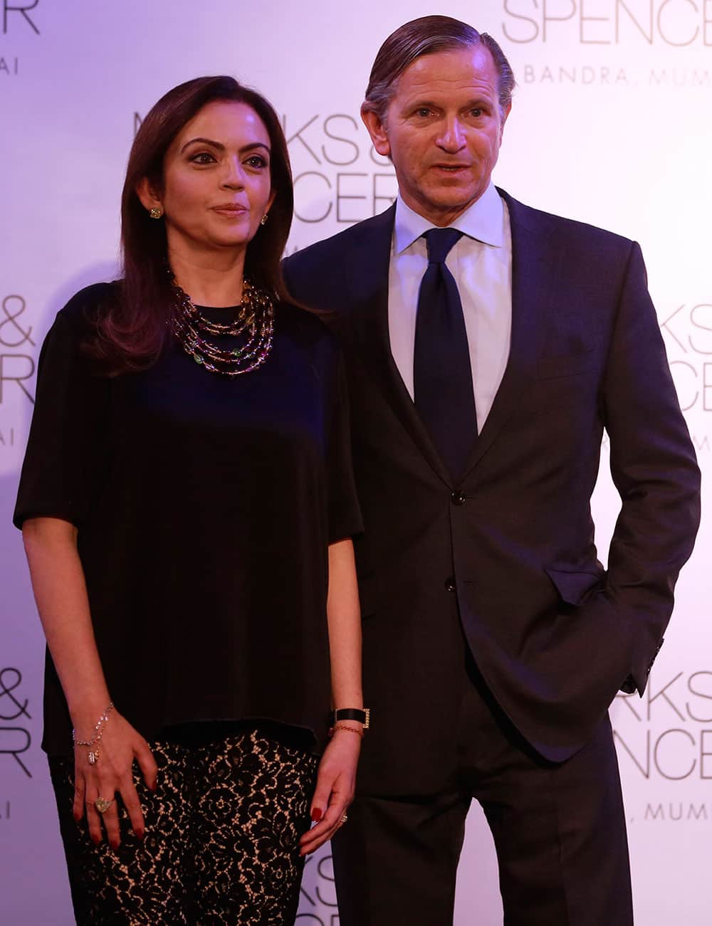 Marks & Spencer chief executive Marc Bolland, poses for photographers with Indian businesswoman Nita Ambani, left during the opening of their biggest store in India, Mumbai, India.