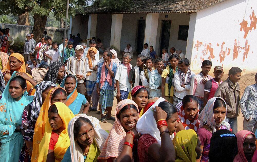 People wait to cast their votes at a polling booth in Dantewada during the first phase of polling for Chhattisgarh Assembly elections.