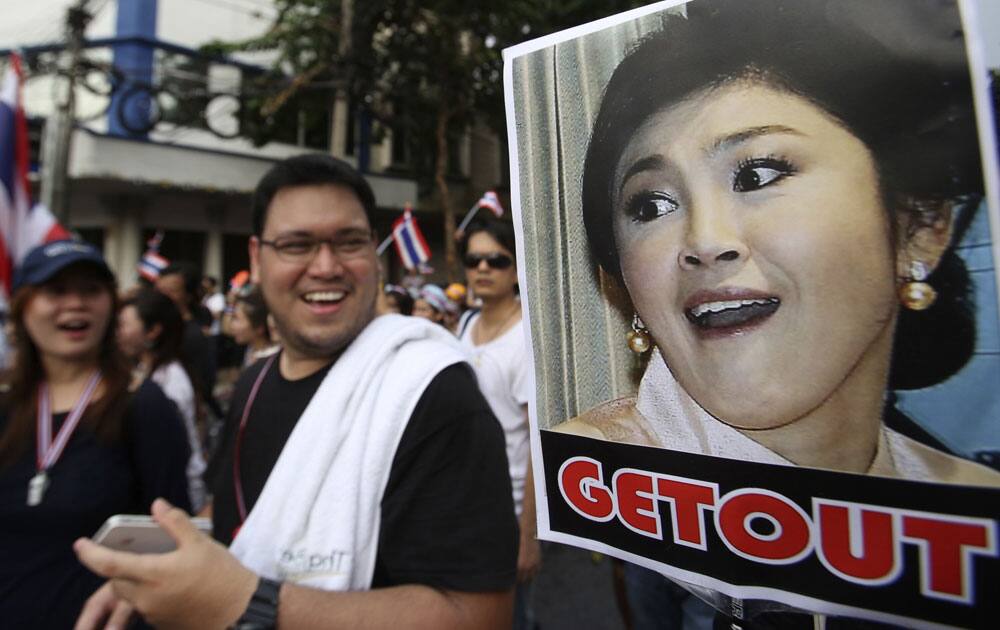 A poster of Thai Prime Minister Yingluck Shinawatra is displayed during a rally, protesting against an amnesty bill in Bangkok, Thailand.