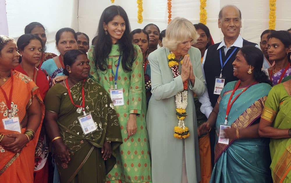 Camilla, the Duchess of Cornwall, center wearing a garland, greets self-employed women during her visit to Vandana Foundation, a women`s non-governmental organization, in Mumbai.
