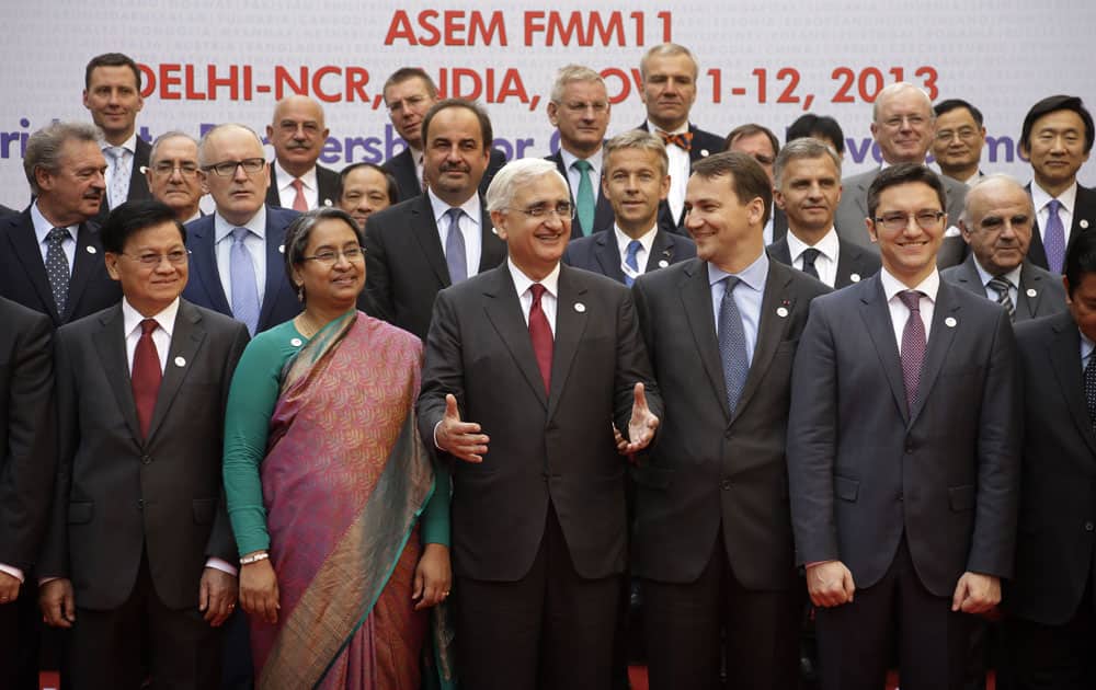 Indian Foreign Minister Salman Khurshid, speaks to his counterparts of Europe and Asia as they pose for a photograph ahead of the Asia and Europe (ASEM) Foreign Ministers’ Meeting in Gurgaon on the outskirts of New Delhi.