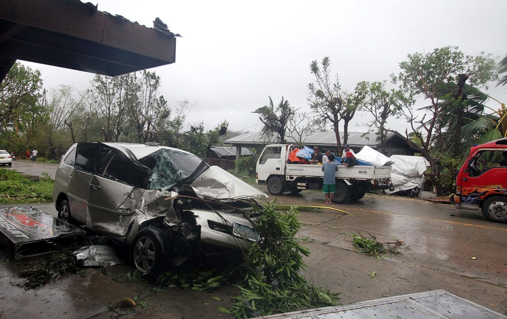 A damaged car sits on a street in Borbon town, north Cebu, central Philippines, after Typhoon Haiyan hit the town.
