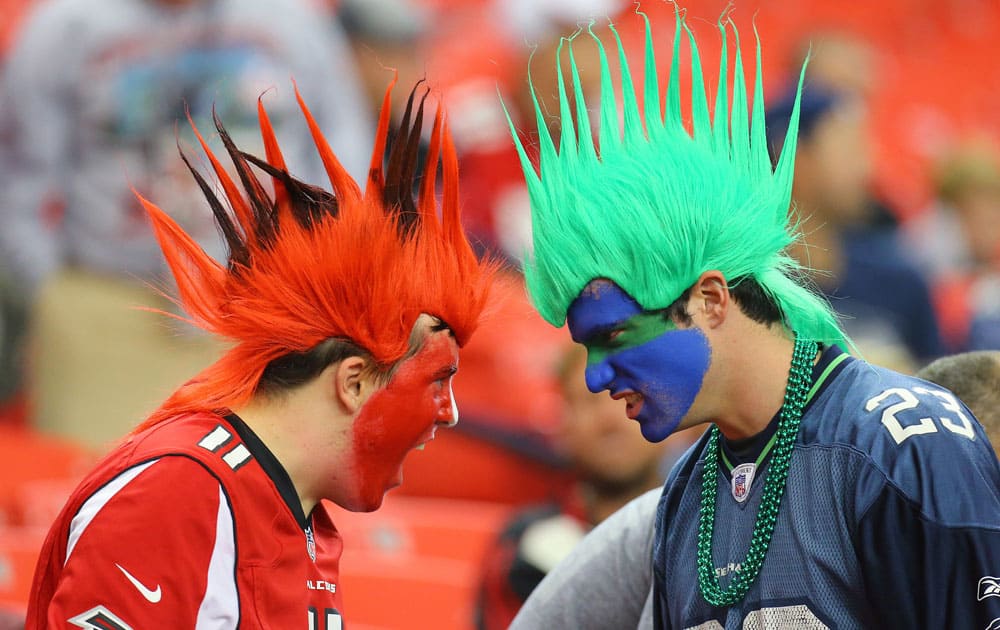 An Atlanta Falcons fan and a Seattle Seahawks fan face-off during the second half of a NFL football game.