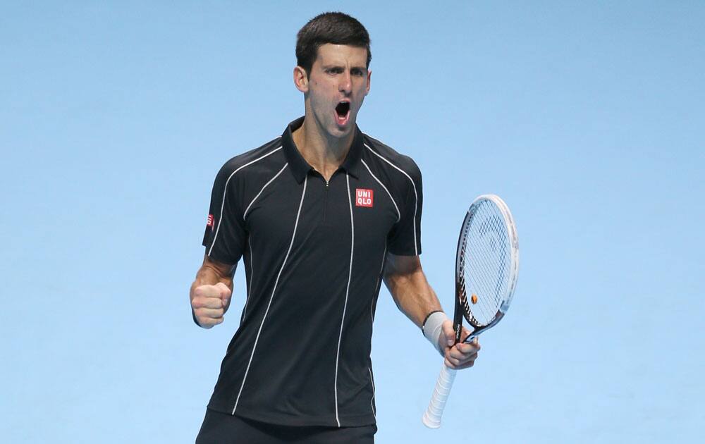 Novak Djokovic of Serbia celebrates as he defeats Stanislas Wawrinka of Switzerland in their ATP world Tour Finals tennis semifinal match at the O2 Arena on London.
