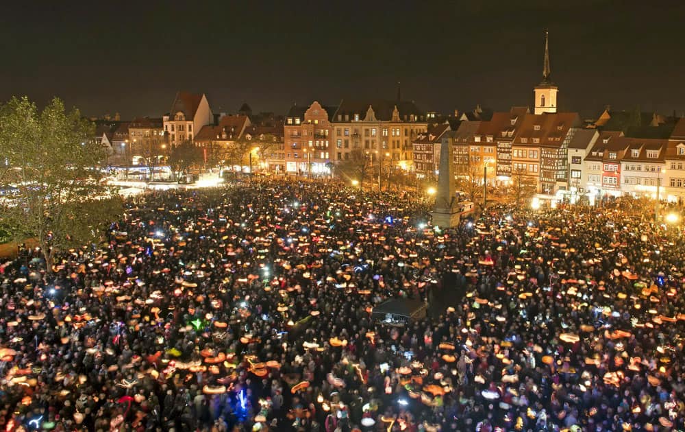 Thousands of people swing their hand lanterns during the ecumenical festival Martini (Day of Martin) in honor of the Catholic St. Martin and of Martin Luther, the Protestant reformer, at the Mariendom place in this timed exposure in Erfurt, central Germany.