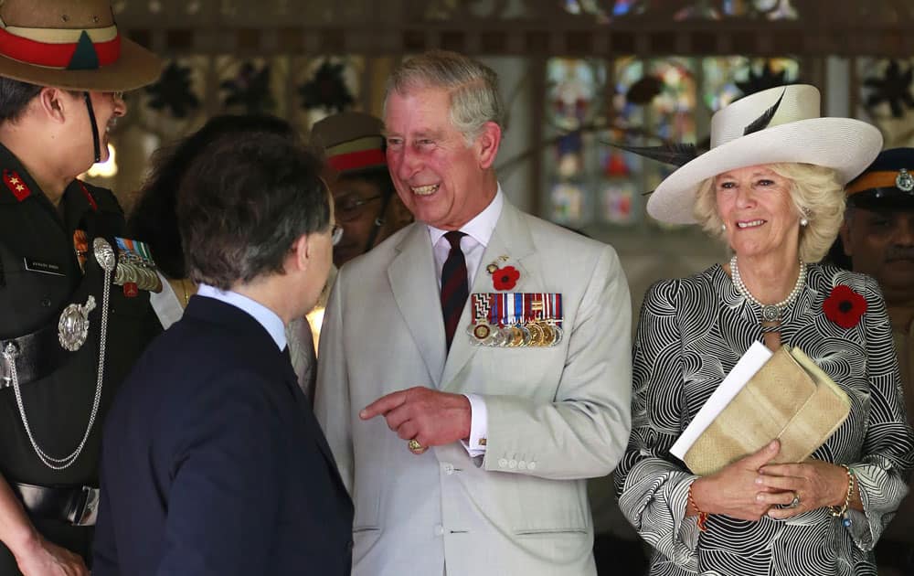 Britain`s Prince Charles, along with his wife Camilla, the Duchess of Cornwall, leave after a Remembrance Day Service at the Afghan Church in Mumbai.