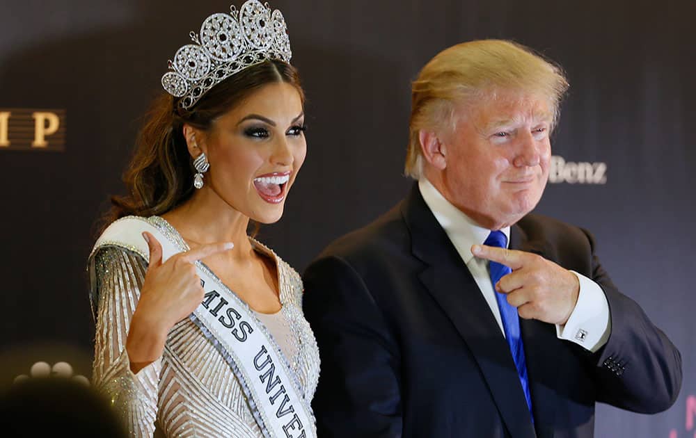 Miss Universe 2013 Gabriela Isler, from Venezuela, left, and pageant owner Donald Trump, of the United States, point to each other while posing for a photo after the 2013 Miss Universe pageant in Moscow, Russia.