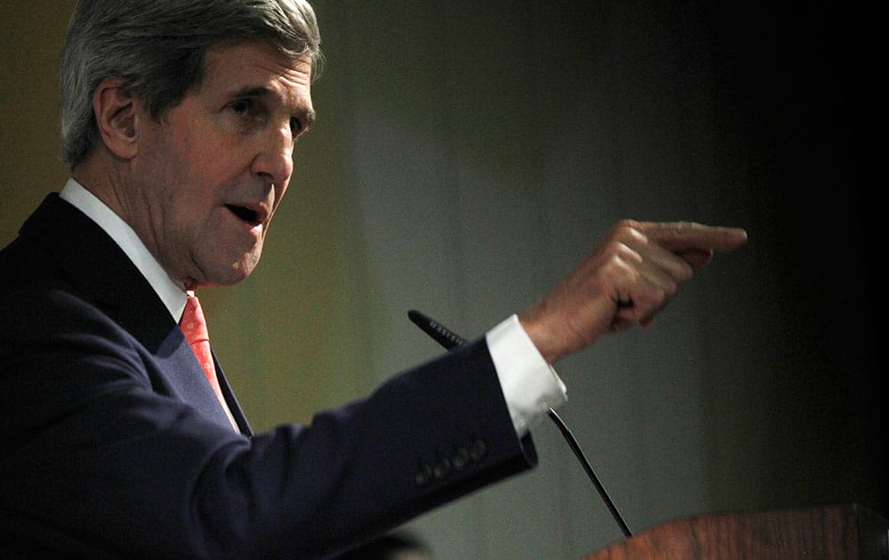 US Secretary of State John Kerry gestures while speaking at a press conference at the end of the Iranian nuclear talks in Geneva.