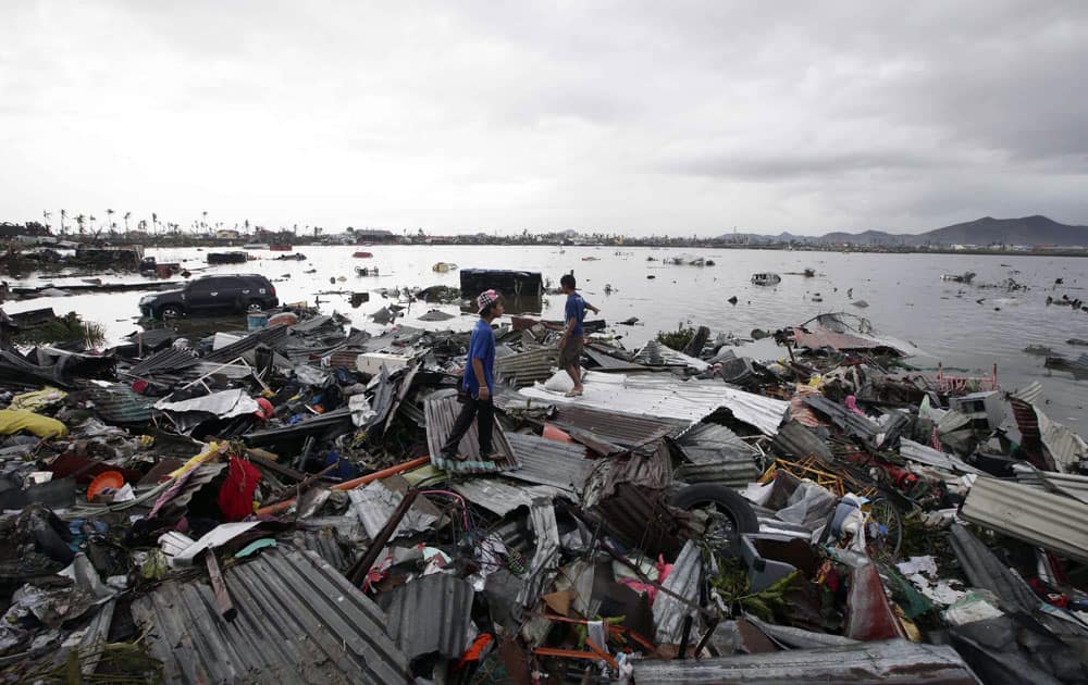 Boys stand on debris from damaged houses in Tacloban city, Leyte province, central Philippines.