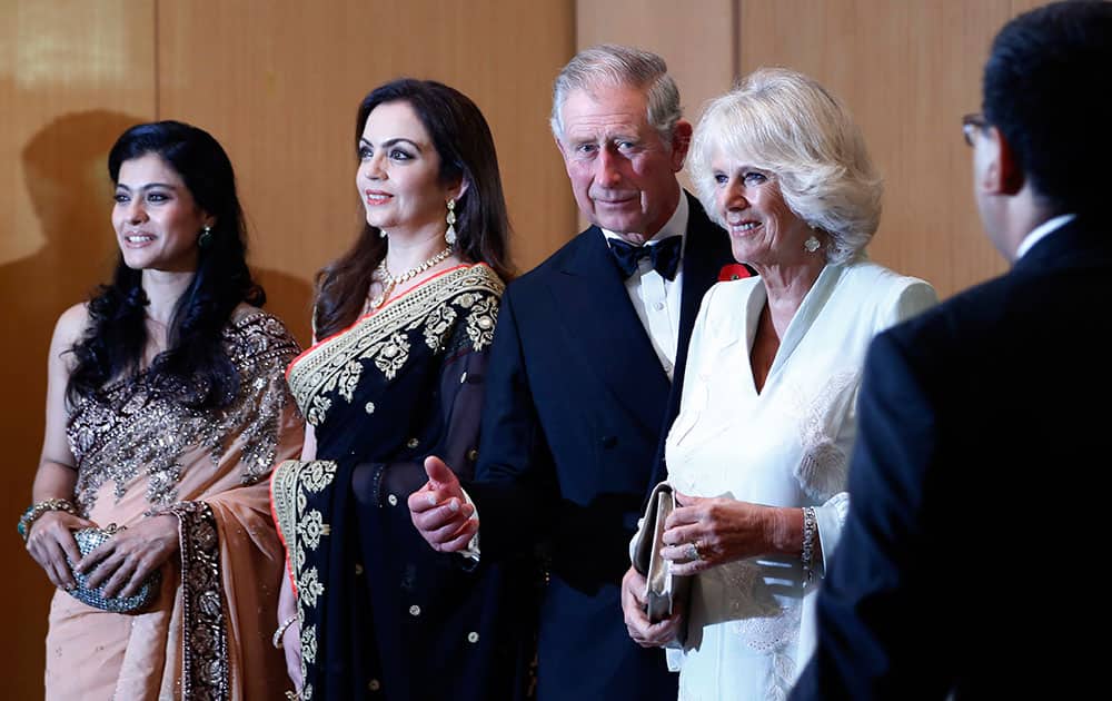 Britain`s Prince Charles and his wife Camilla, the Duchess of Cornwall, stand with Bollywood actress Kajol, left, and businesswoman Nita Ambani, 2nd left, before a dinner to support the work of British Asian Trust in Mumbai.