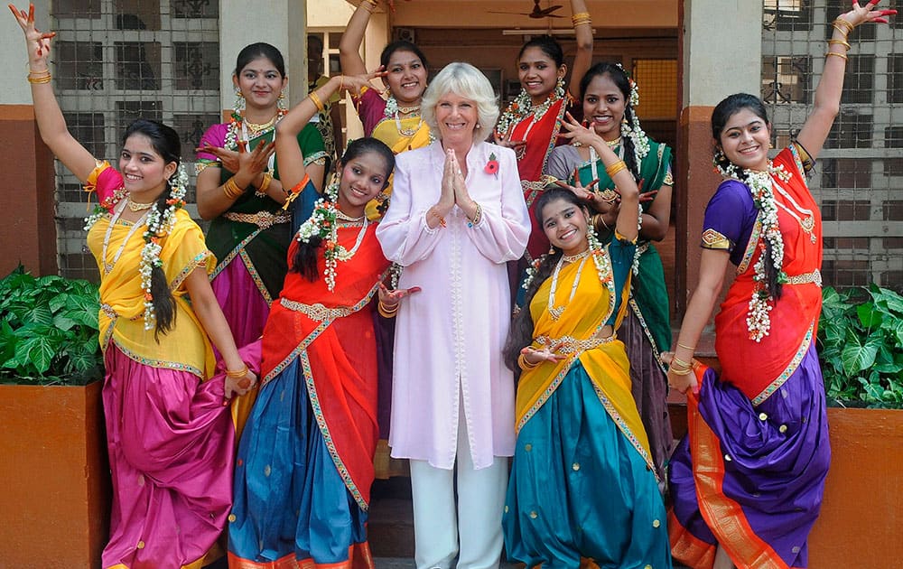 Camilla, Duchess of Cornwall, poses with students during a visit to the Asha Sadan children`s home in Mumbai, India. Britain`s Prince Charles and his wife Camilla are on a nine day visit to India.