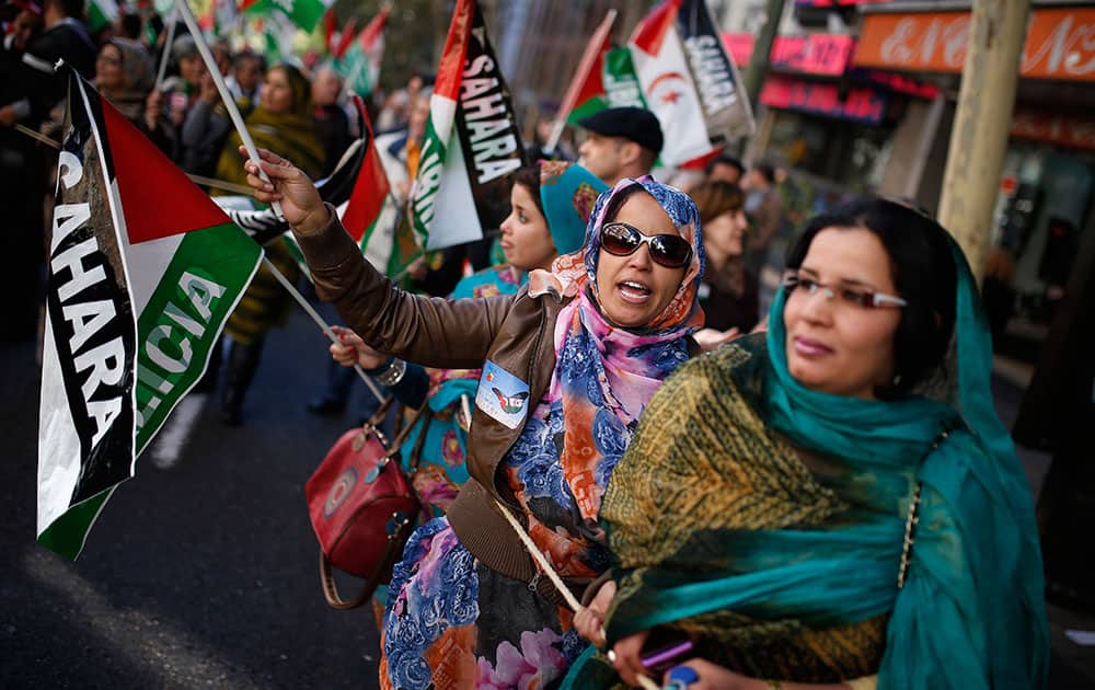 Women from Western Sahara shout slogans as they wave Western Sahara`s flags in support of Free Western Sahara during a protest in Madrid.