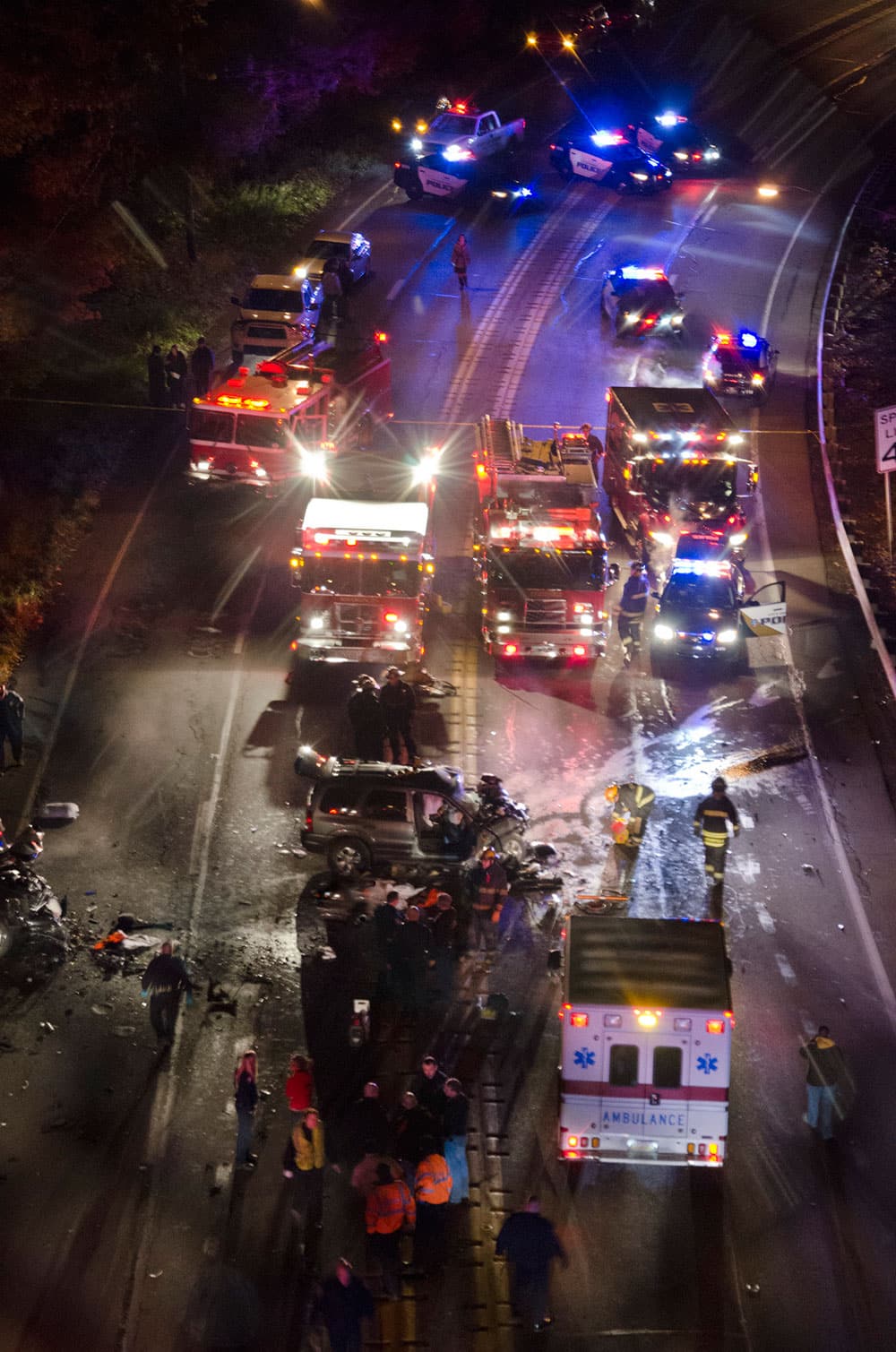 Rescue crews from four departments respond to a deadly two-vehicle crash along the Shenango Valley Freeway, Friday, Nov. 8, 2013 in Sharon, Pa. Two high school football players died Friday night in the crash that also killed a third person, according to state high school sports officials.