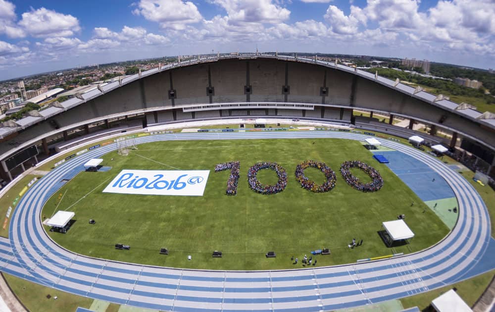 This photo released by Rio 2016 Organizing Committee for the Olympic and Paralympic Games, youths form the number 1,000 to mark the number of days before the start of the Rio 2016 Olympic Games inside Mangueirao stadium in Belem, Brazil.