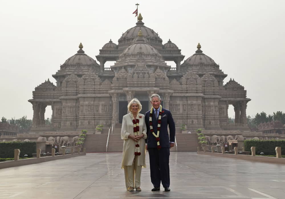 Britain`s Prince Charles and his wife Camilla, the Duchess of Cornwall, stand in front of Akshardham Temple in New Delhi.