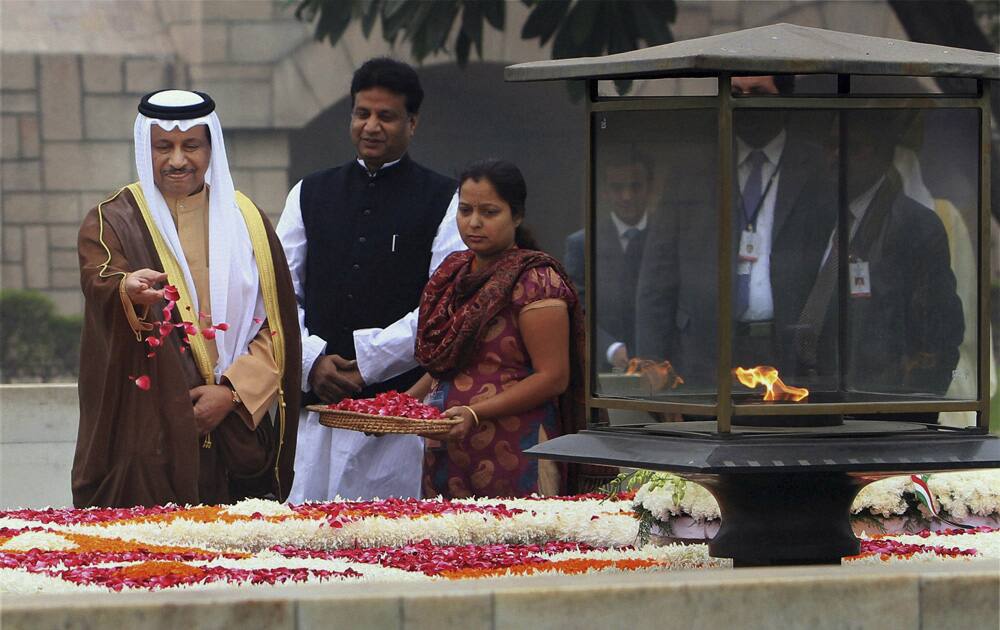 Kuwait’s Prime Minister Sheikh Jaber Al-Mubarak Al-Hamad Al-Sabah throws flowers during a visit to Rajghat, the memorial to the late Mahatma Gandhi, in New Delhi.
